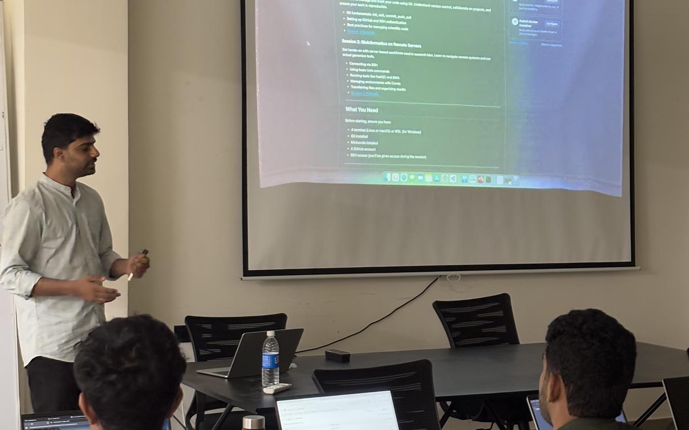 A session with code on the screen and laptops open