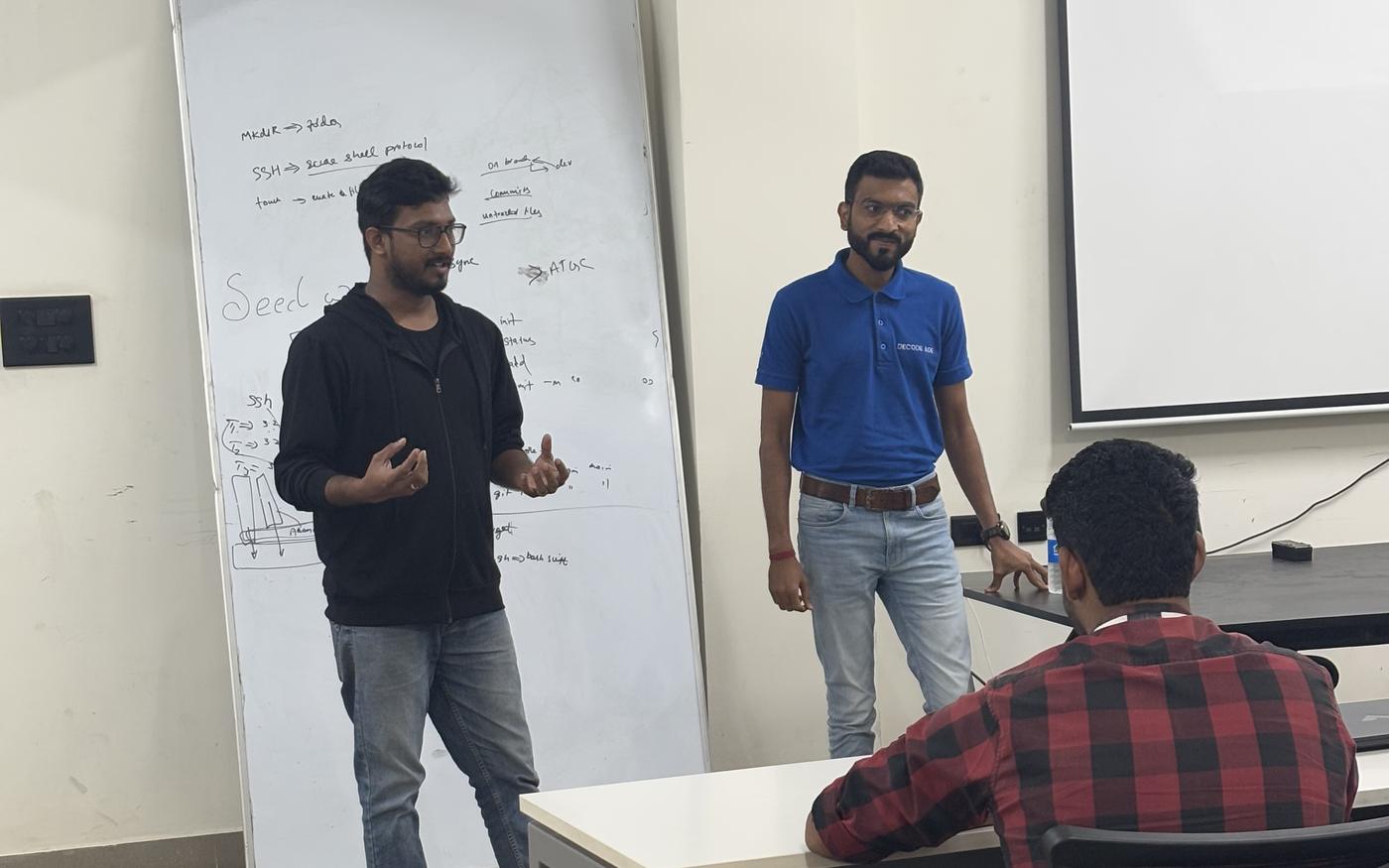 Two people presenting at a whiteboard